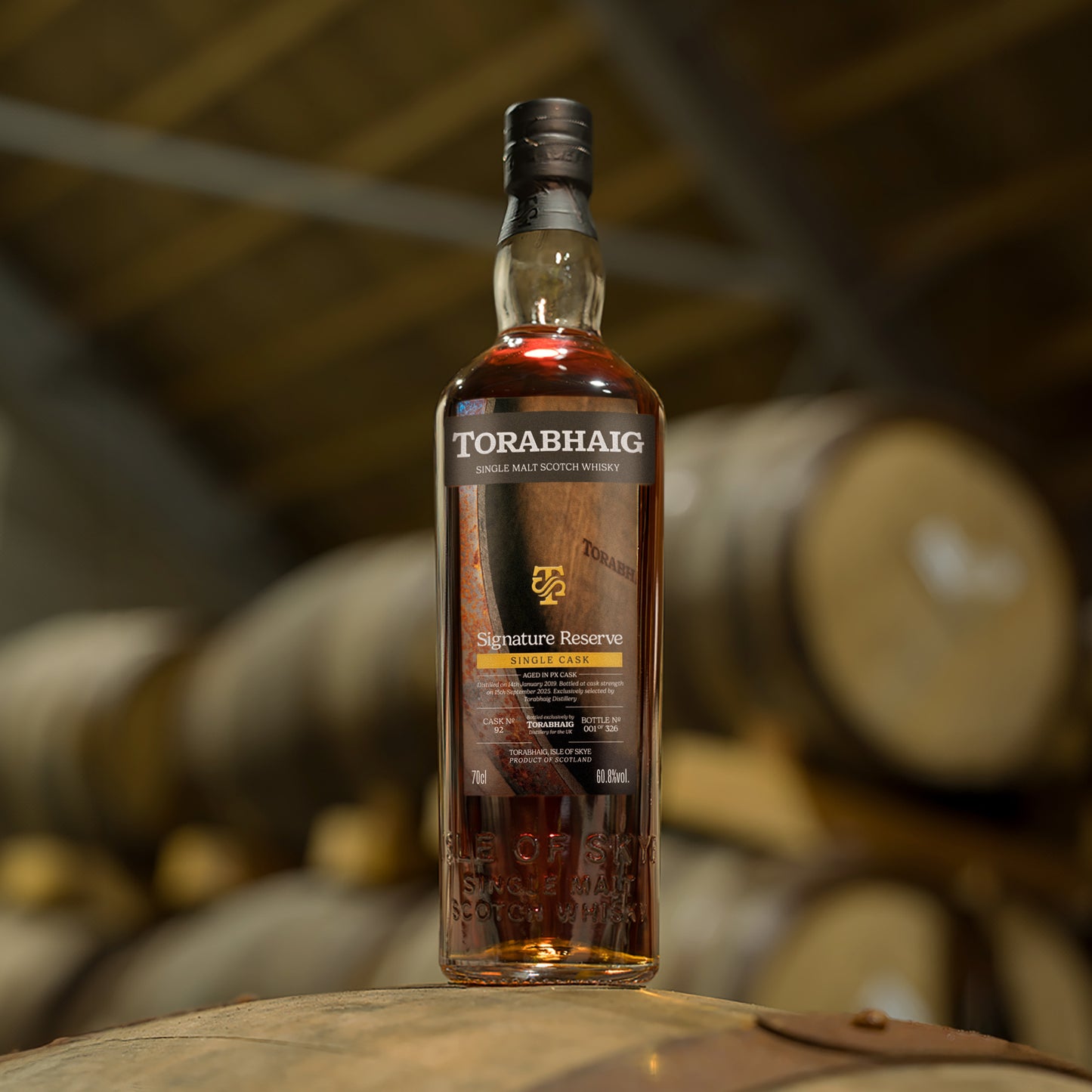 Torabhaig Signature Reserve single malt whisky bottle on cask in warehouse