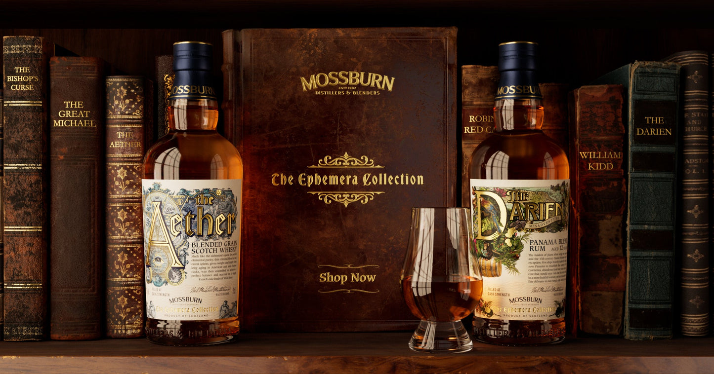 Torabhaig Ephemera Collection Aether and Darien single malt whisky bottles flanking book with whisky glass on shelf